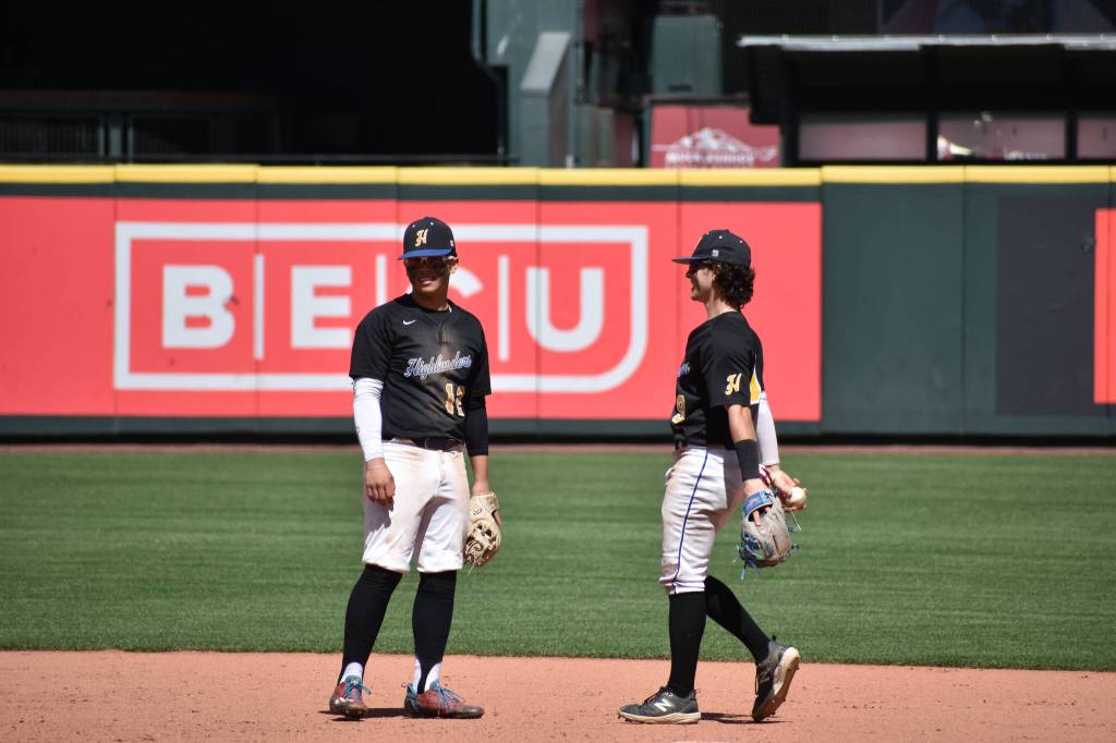 Marcus McCarthy and Morrie Solam talk shop around second base at T-Mobile Park. Ben Ray / The Reporter
