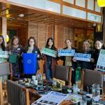 The outreach event at Anchovies and Salt. Meara Huebach and others are holding up some of the free supplies that program participants can receive. Photo courtesy of Meara Huebach