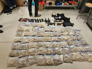 Police found a firearm and firearms parts, ammunition, body armor, more than 134 pounds of MDMA, more than 2,300 fentanyl pills, and more in a 33-year-old Auburn mans apartment while executing a search warrant. (Courtesy of the U.S. Department of Justice)