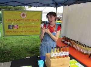 Raine Padawer, employee of Papa Tonys, with her favorite flavor of hot sauce, the Ghostly Garlic. Photo courtesy of Annika Hauer
