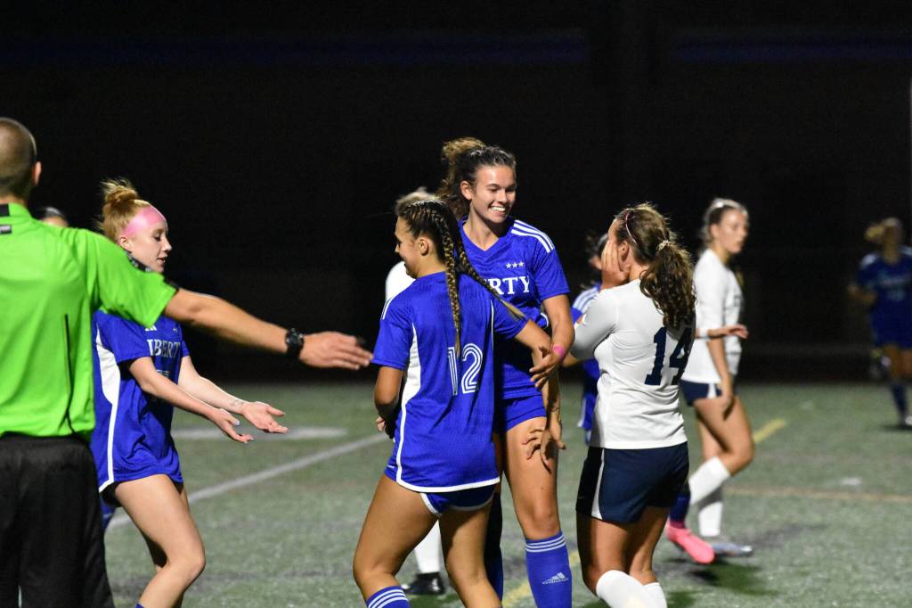 Liberty players Isa Wiegering (right) and Casey Smith (left) celebrate the Patriots fourth goal of the game. Ben Ray / The Reporter
