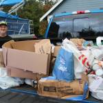 Marc shows off the food donations that he will drive to the Renton Salvation Army in November. Photo by Bailey Jo Josie/Sound Publishing.