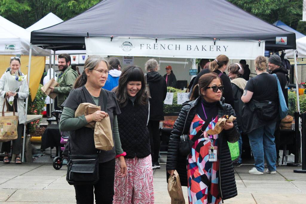 Renton Farmers Market attendees enjoy some bakery goods in June. Photo by Bailey Jo Josie/Sound Publishing.