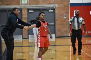 Isaac Elegan shakes hands with Head Coach Rashaad Powell in the win over Lindbergh. Ben Ray / The Reporter