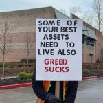A Costco truck driver holds up a homemade sign at the Teamsters rally, Jan. 23, 2025. (Grace Gorenflo/Valley Record)