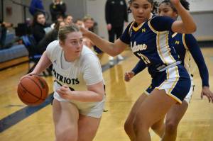 Ella Whitaker drives to the basket against Bellevue. Ben Ray / The Reporter