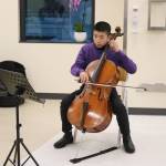A young cellist performs music in one of the Infusion bays of the new center. Photo by Bailey Jo Josie/Sound Publishing.