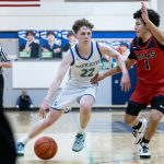 Jackson Whitaker dribbles the basketball past a defender. Photo taken by Maria Dorsten.