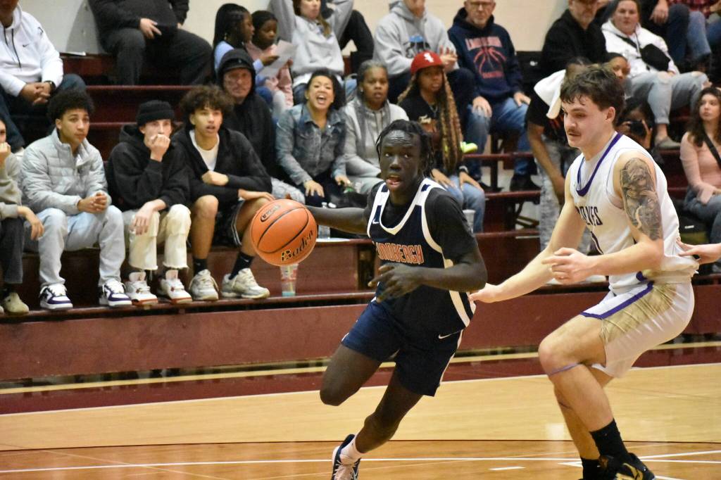Senior John Choul drives to the basket in the first half against Sequim. Ben Ray / The Reporter