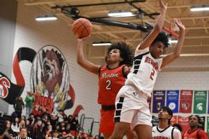 Jordan Agosto goes up for a lay-up with the back of a Sammamish defender on his side. Ben Ray / The Reporter