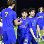Stephen Cruz high fives Vitaly Polyukh after scoring the second Hazen goal of the game. Ben Ray / The Reporter