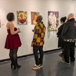 Artists and art-lovers alike admire the art displayed at Vargas Rebel Beauties exhibit. The piece on the far right was created by Rentons own Ashley Dobson. Photo by Bailey Jo Josie/Sound Publishing.