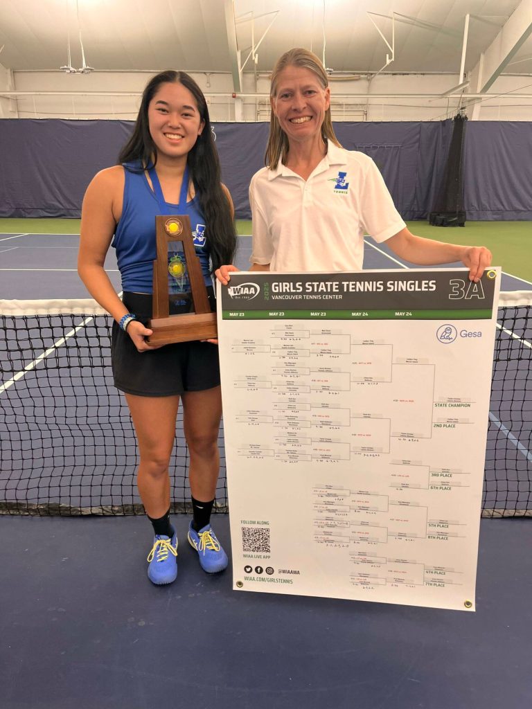 Tayler Conway and Head Coach Carola Dopps celebrate first place. Ben Ray / The Reporter