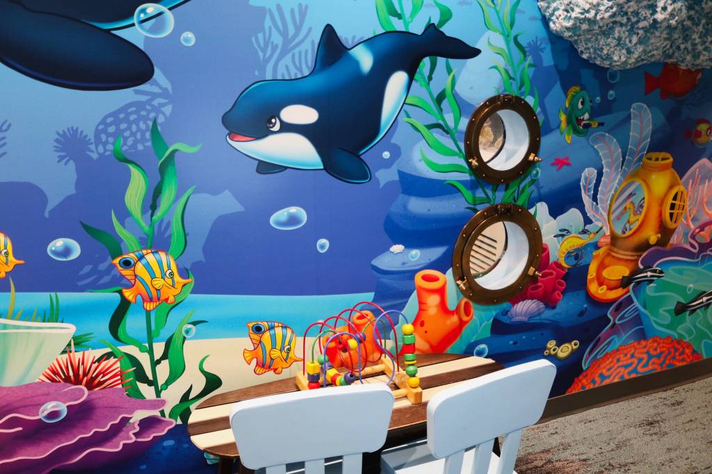 Portholes in the wall allows kids to look in on the dentists doing their work.