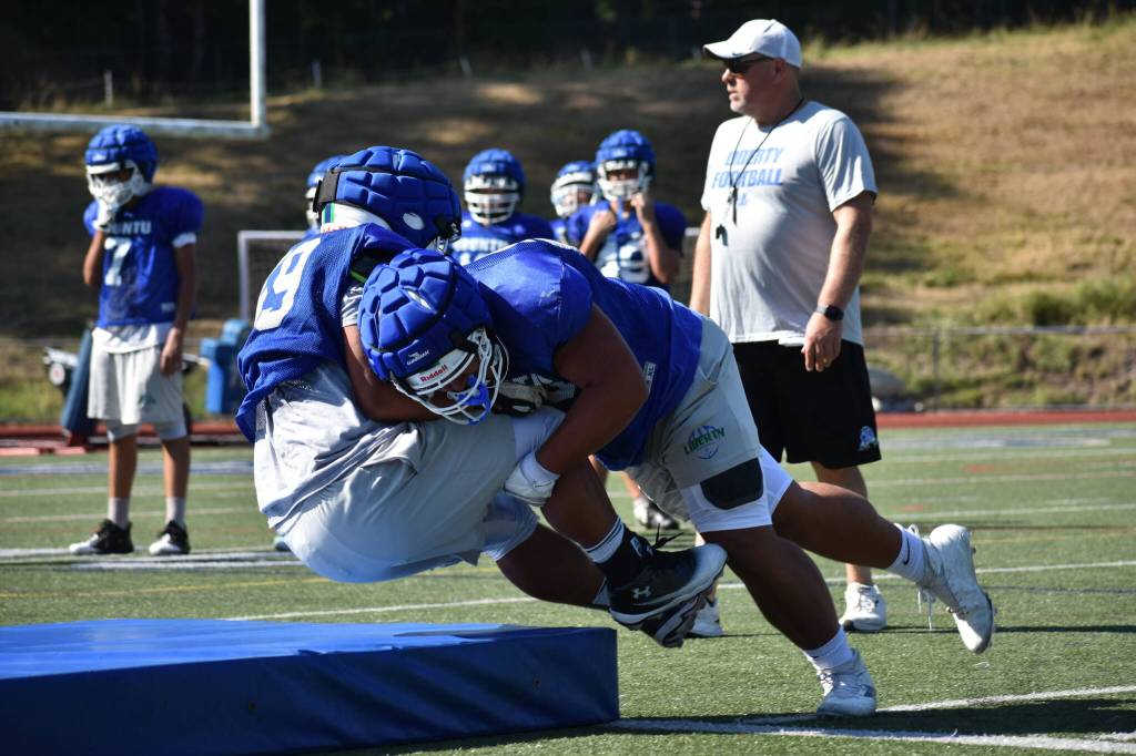 Tackle drills at Liberty High School. Ben Ray / The Reporter