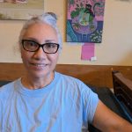 Luna Zuniga poses in front of her oil painting Bella the Cat. Photo by Bailey Jo Josie/Sound Publishing