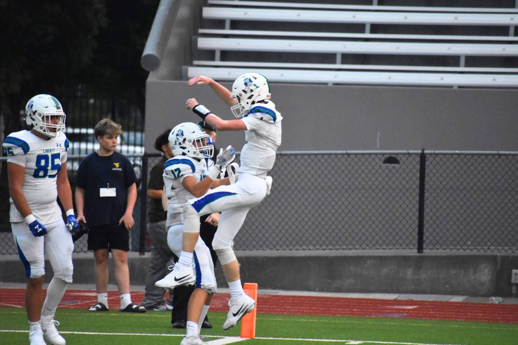 Dawson Durham jumps into Tyke Hamilton after scoring the games first points. Ben Ray / The Reporter