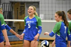 Avery Bange smiles as Liberty win a point against the Edmonds-Woodway Warriors. Ben Ray / The Reporter