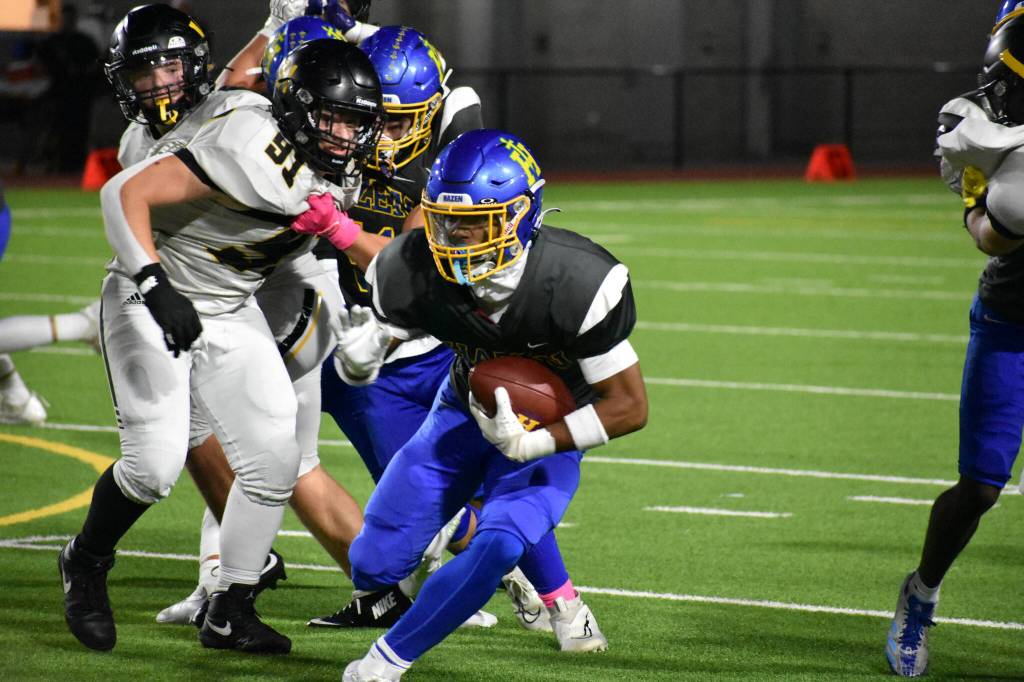 Running back Major Bloodsaw keeps his eyes down field as he runs for the Highlanders lone touchdown. Ben Ray / The Reporter