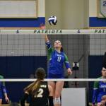 Julianne Lee with a tip over the net against Issaquah. Ben Ray / The Reporter