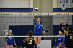 Julianne Lee with a tip over the net against Issaquah. Ben Ray / The Reporter