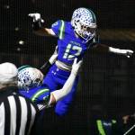 Tyke Hamilton lifted up after an interception taken back for a touchdown. Ben Ray / The Reporter