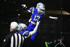 Tyke Hamilton lifted up after an interception taken back for a touchdown. Ben Ray / The Reporter