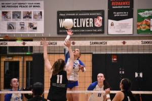 Avery Bange with a spike against Bellevue. Ben Ray / The Reporter