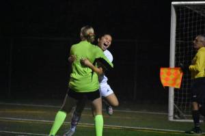 Peyton Warns and Mylene Augila embrace each other after beating Gig Harbor. Ben Ray / The Reporter