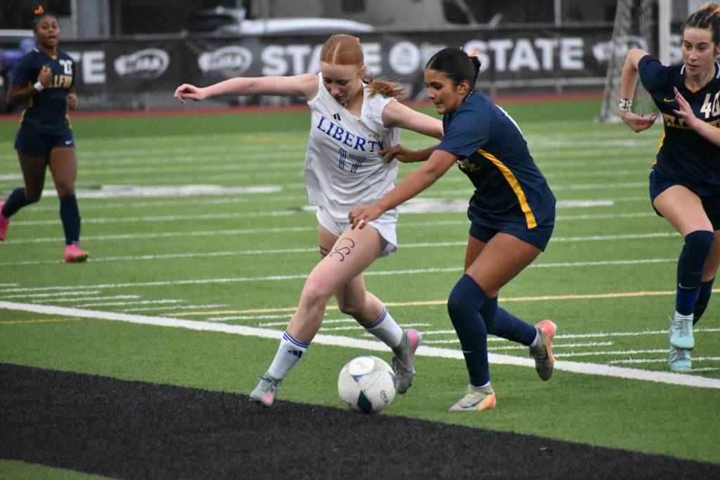 Morgan Ackermann fights off a Bellevue defender. Ben Ray / The Reporter
