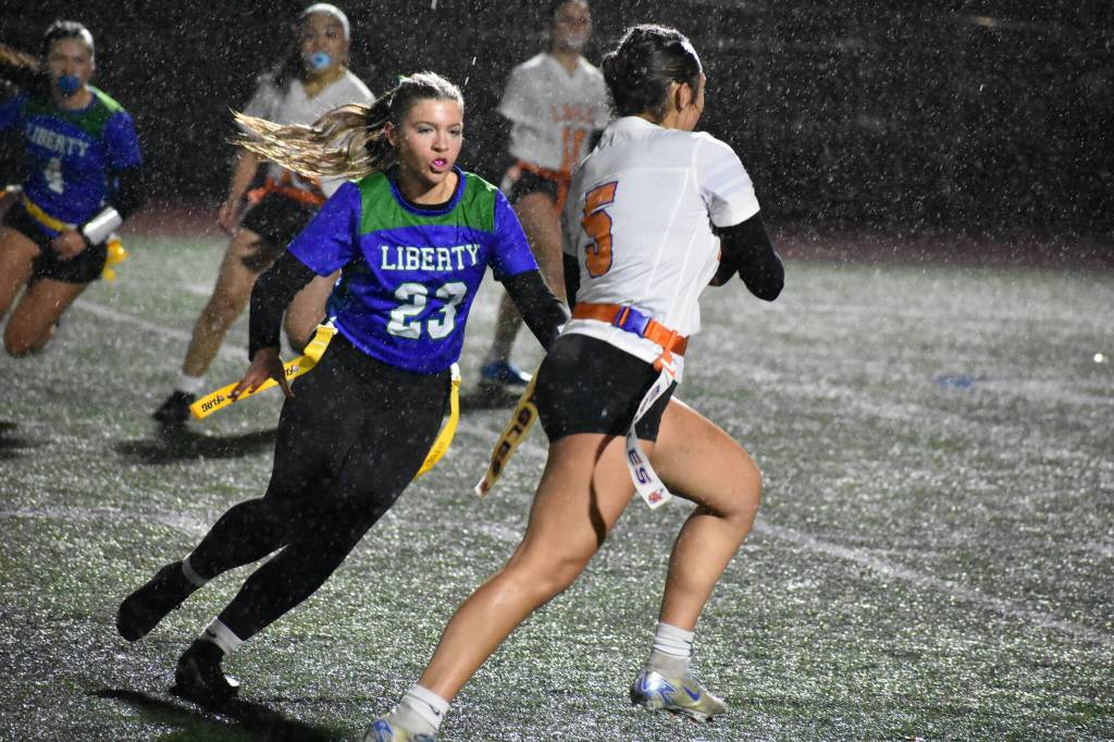 Tegan Peeples goes for the flag pull in the rain against Graham Kapowsin. Ben Ray / The Reporter