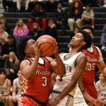 Isaac Elegan drives to the basket against Auburn High School. Ben Ray / The Reporter