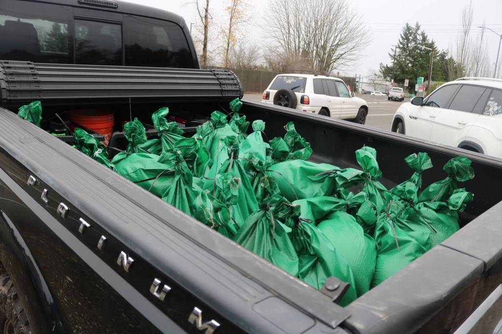 Pickup trucks and other vehicles have been traveling back and forth between the public sandbag station and the Maplewood neighborhood since 6 a.m. Dec. 11. Photo by Bailey Jo Josie/Sound Publishing