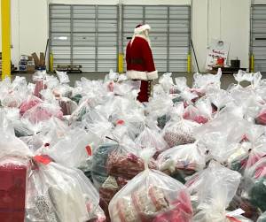 Santa stands among a sea of presents at the North Pole. Photo courtesy of Greg Bakke.