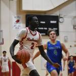 Rentons Sudan Luok picks up the basketball en route to a dunk against Liberty. Ben Ray / The Reporter