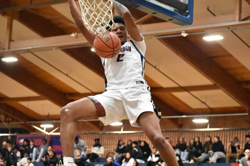 James Huff IV dunks the ball against Sequim for Lindbergh. Ben Ray / The Reporter