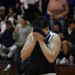 Lindberghs Trinidad Valentino English covers his face after falling to Sequim in the state tournament.