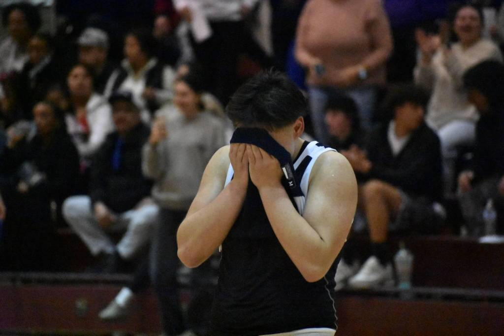 Lindberghs Trinidad Valentino English covers his face after falling to Sequim in the state tournament.