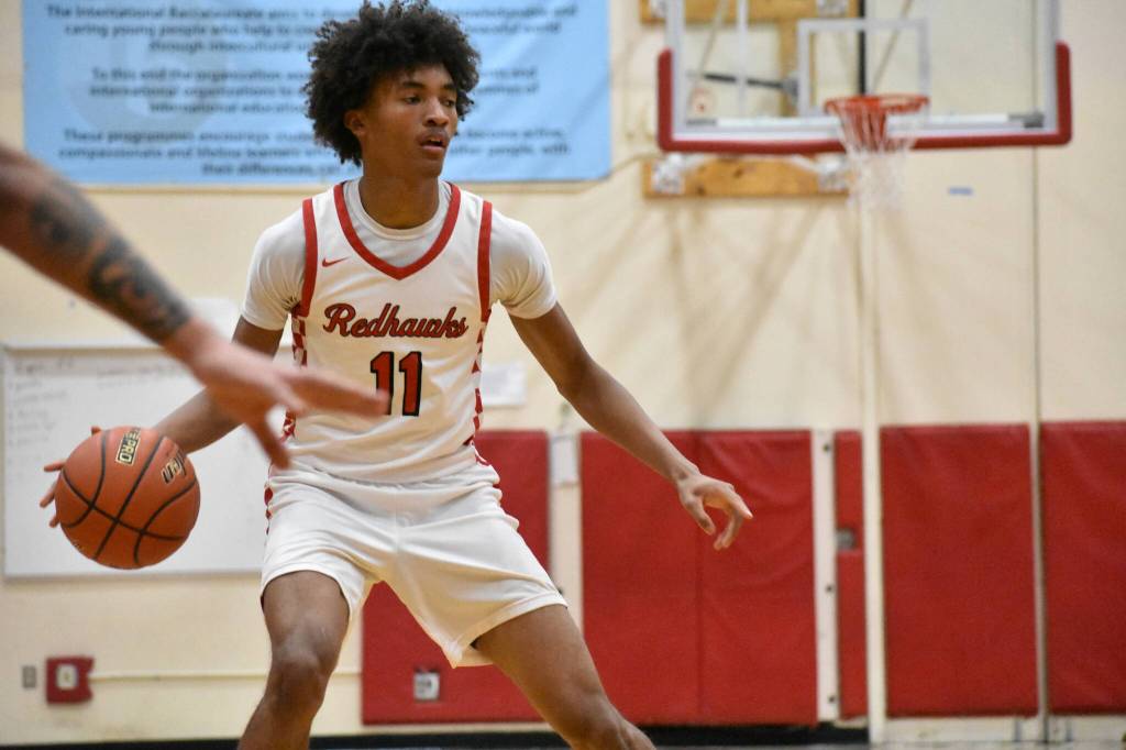 Juice White-Kelley dribbles the basketball for Renton. Ben Ray / The Reporter