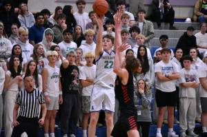 Jackson Whitaker takes a three point shot against Mount Si. Ben Ray / The Reporter