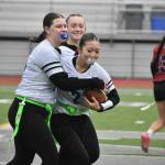 Marisa Aoki celebrated by her teammates after scoring a game tying touchdown. Photos by Ben Ray / The Reporter