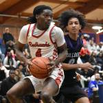 Nate Omar holds the basketball for Renton against Foster. Ben Ray / The Reporter