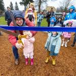 Renton Mayor Armondo Pavone cuts the ribbon with a little helper.