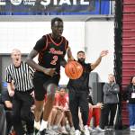 Sudan Luok dribbles the ball up the floor on a fast break for the Redhawks. Ben Ray / The Reporter