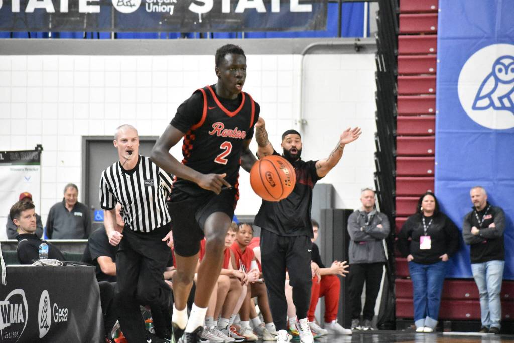 Sudan Luok dribbles the ball up the floor on a fast break for the Redhawks. Ben Ray / The Reporter