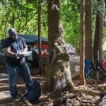 Kent Hay delivering mail to a resident of a homeless camp in Auburn on Aug. 27, 2021. Sound Publishing file photo