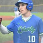 Tristan Klein gives a fist bump after scoring for Liberty. Ben Ray / The Reporter
