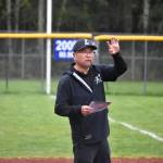 Joon Huh gives a sign from the third-base line. Ben Ray / The Reporter