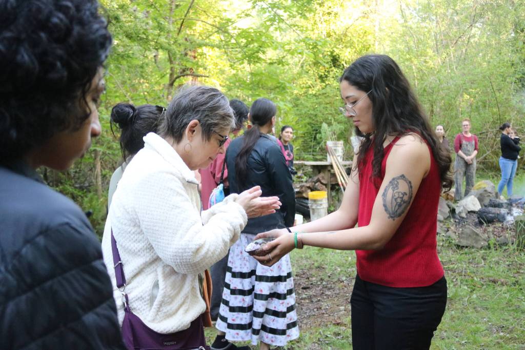 Community members perform a smudging ceremony. Photo by Bailey Jo Josie/Sound Publishing.