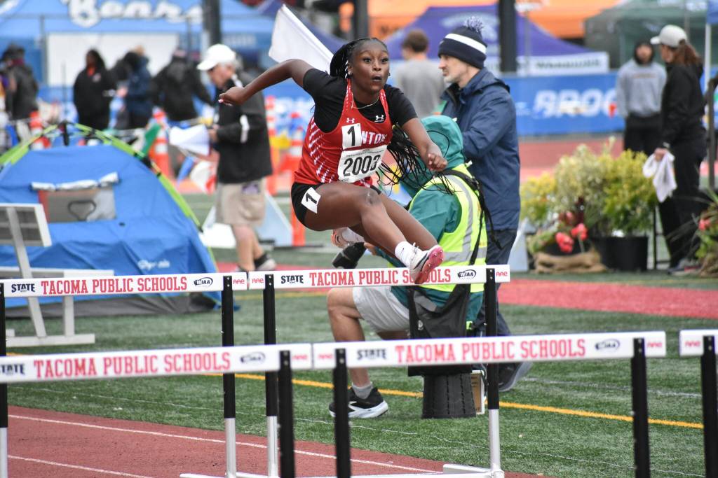 Brooklyn Kimp-Stephens leaps over hurdles for Renton. Ben Ray / The Reporter